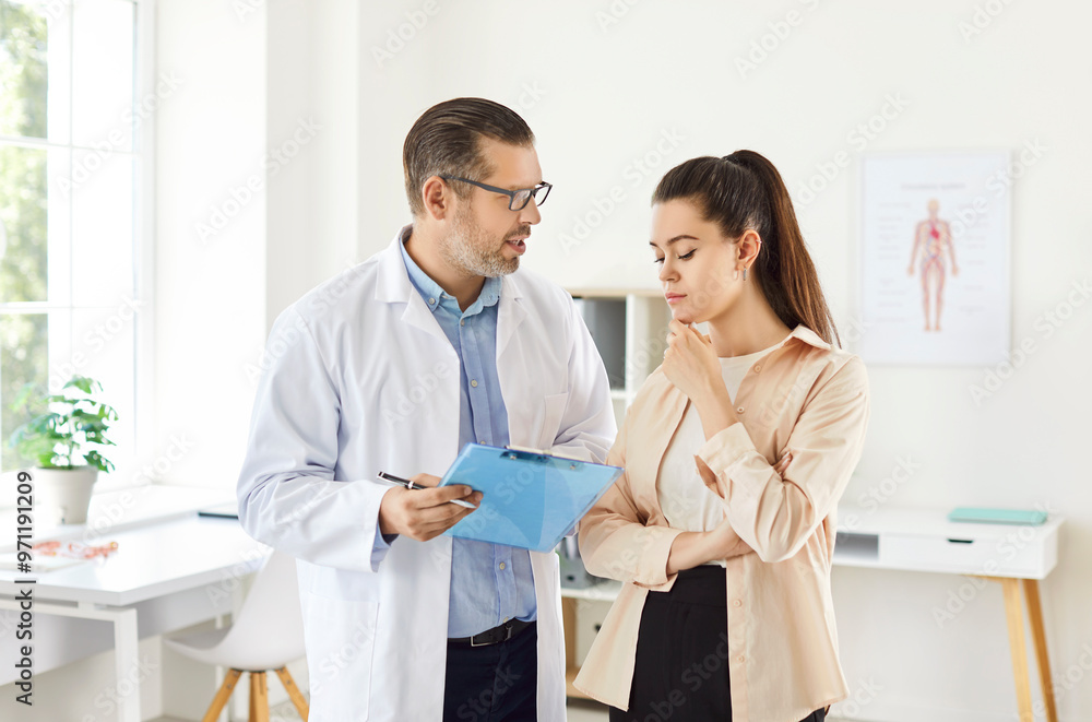 Doctor or nurse provides medical consultation to a female patient during a hospital office visit. The healthcare professional offers support and advice to ensure the patient well being and treatment. Doctor or nurse provides medical consultation to a female patient during a hospital office visit. The healthcare professional offers support and advice to ensure the patient well being and treatment.