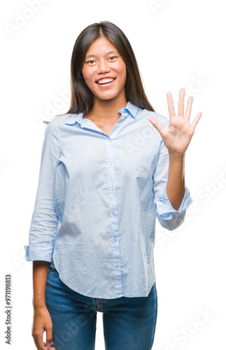 Young asian business woman over isolated background showing and pointing up with fingers number five while smiling confident and happy.