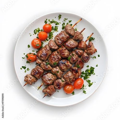 Skewered grilled meat with cherry tomatoes and fresh herbs on a white plate photo