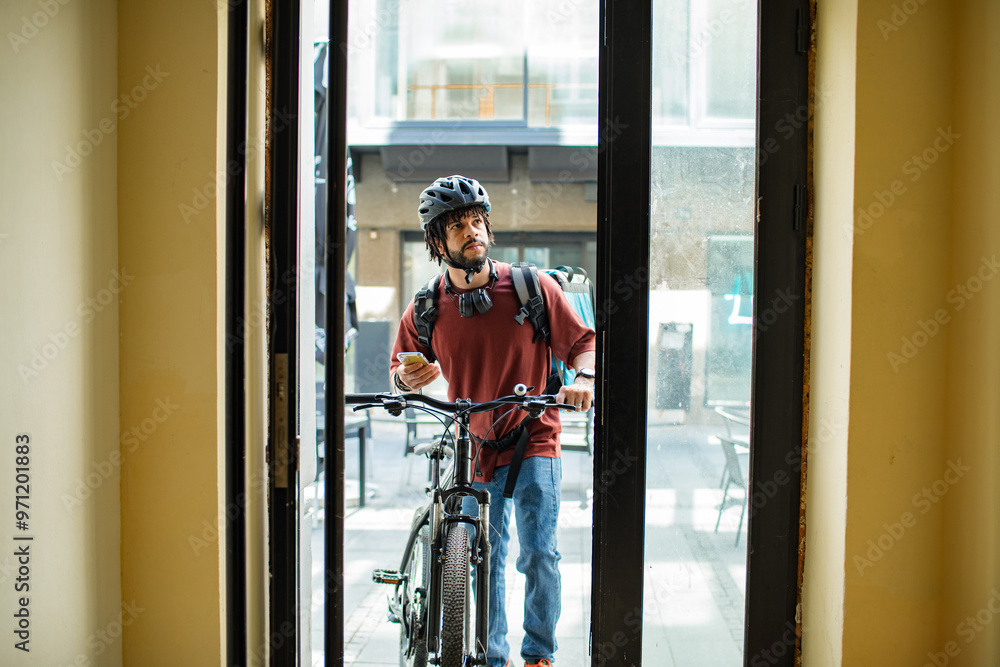Food delivery man checking address on smartphone Food delivery man checking address on smartphone