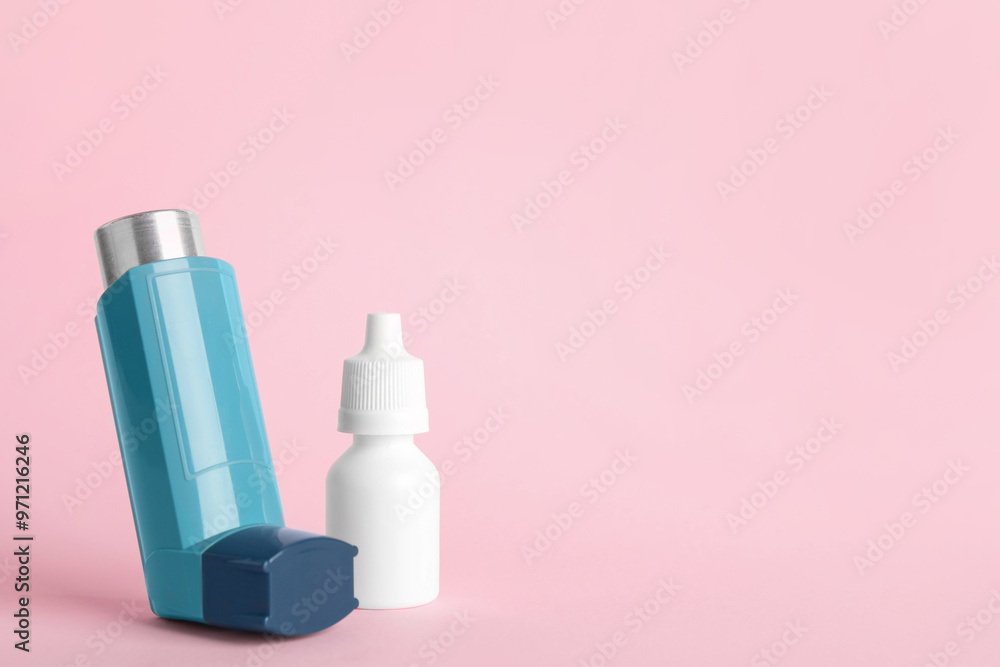 Asthma inhaler and medical drops on pink background, closeup. Space for text Asthma inhaler and medical drops on pink background, closeup. Space for text