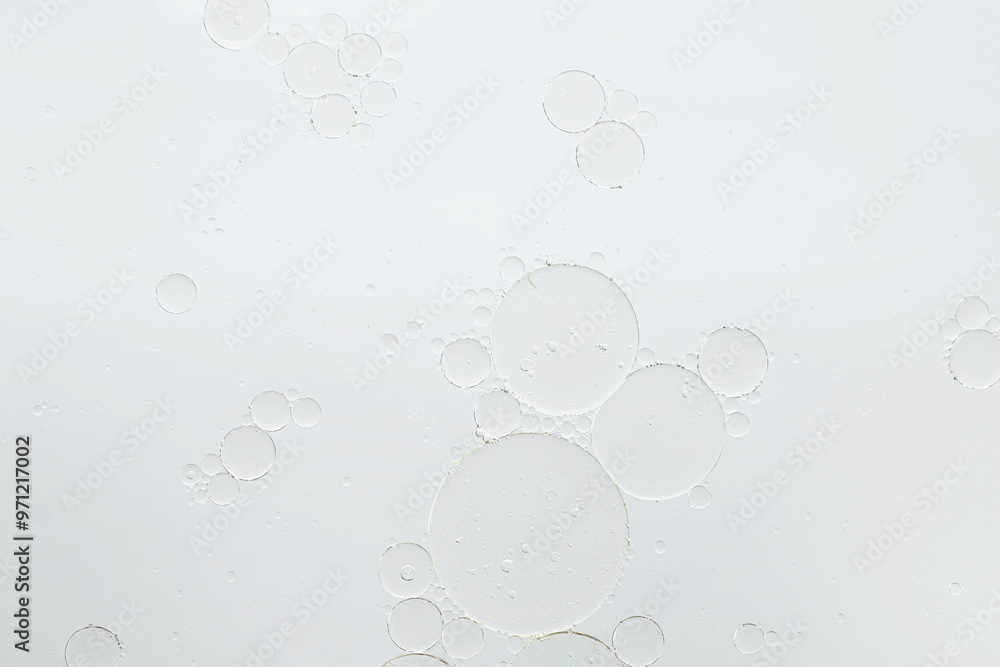 Essential oil bubbles on white background, macro view. Cosmetic product Essential oil bubbles on white background, macro view. Cosmetic product
