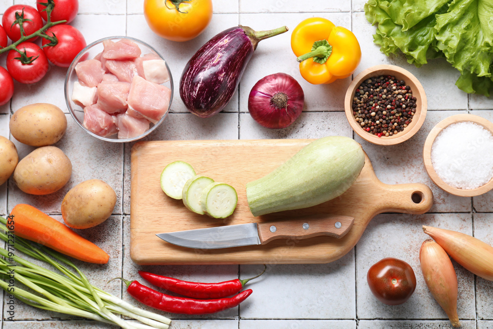 Uncooked ingredients for stew on tiled table, flat lay Uncooked ingredients for stew on tiled table, flat lay