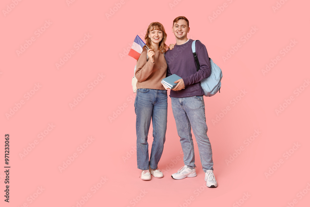 Students with French flag and books on pink background Students with French flag and books on pink background