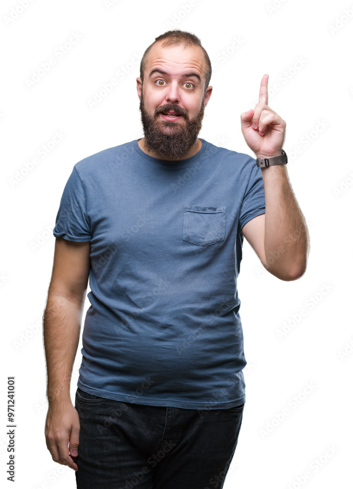 Young caucasian hipster man over isolated background pointing finger up with successful idea. Exited and happy. Number one. Young caucasian hipster man over isolated background pointing finger up with successful idea. Exited and happy. Number one.