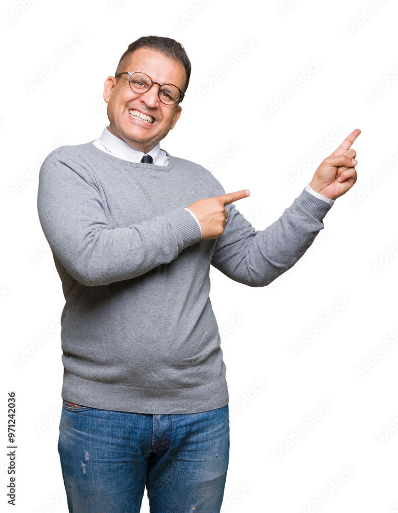 Middle age bussines arab man wearing glasses over isolated background smiling and looking at the camera pointing with two hands and fingers to the side. Middle age bussines arab man wearing glasses over isolated background smiling and looking at the camera pointing with two hands and fingers to the side.