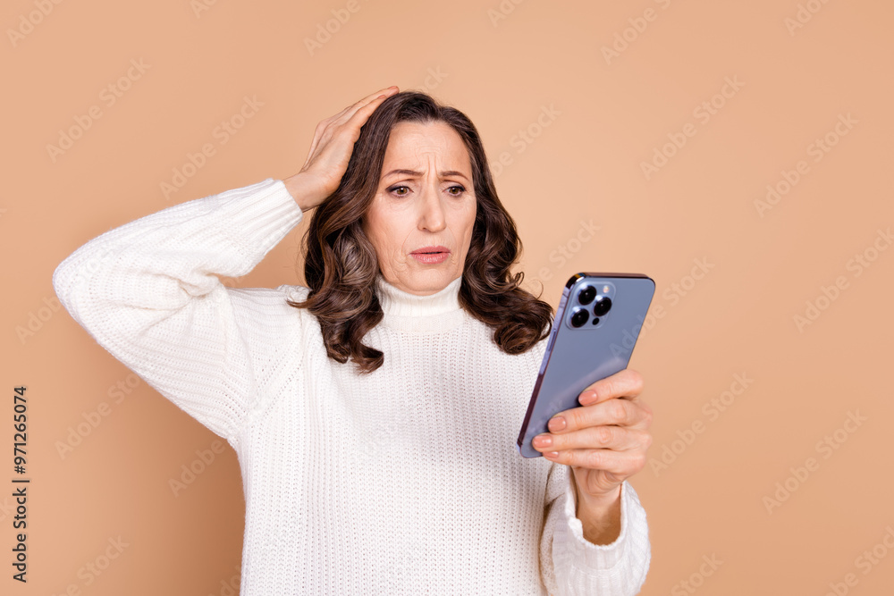 Photo of stressed depressed senior woman wear white stylish clothes touch head isolated on beige color background Photo of stressed depressed senior woman wear white stylish clothes touch head isolated on beige color background
