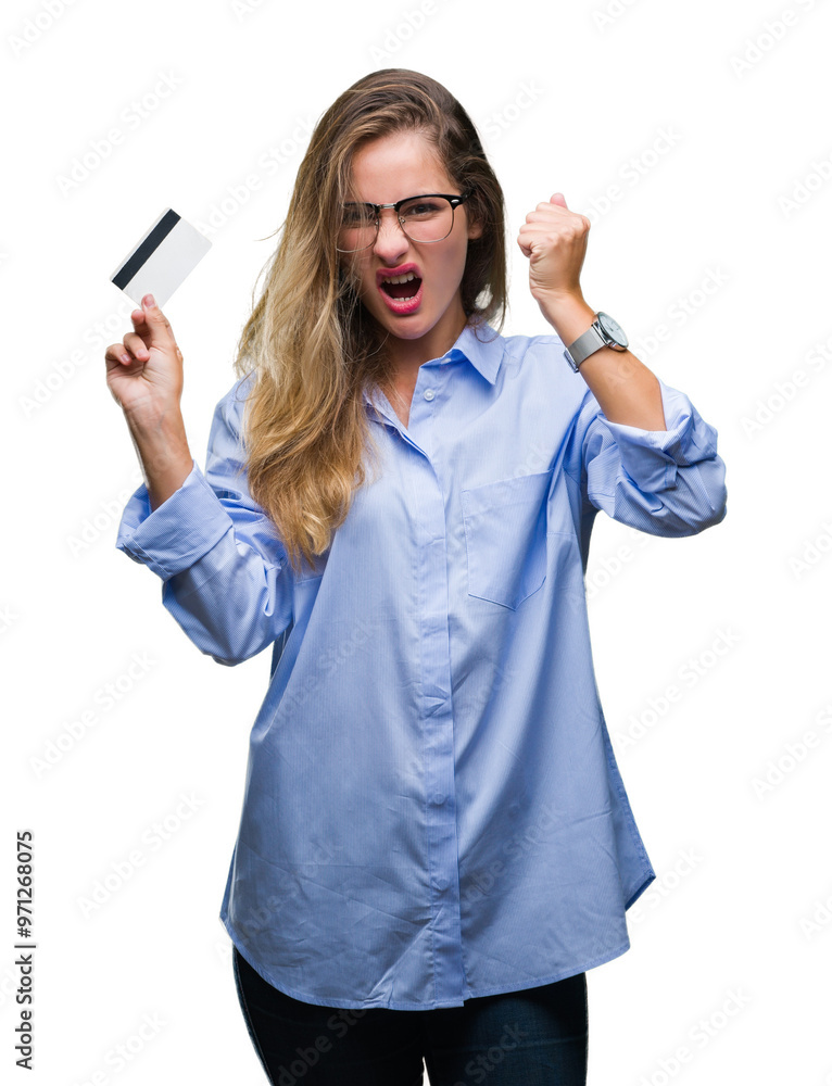 Young beautiful blonde woman holding credit card over isolated background annoyed and frustrated shouting with anger, crazy and yelling with raised hand, anger concept Young beautiful blonde woman holding credit card over isolated background annoyed and frustrated shouting with anger, crazy and yelling with raised hand, anger concept