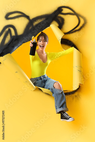 Young girl with spray can o...