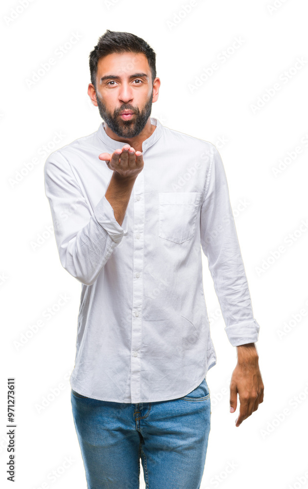 Adult hispanic man over isolated background looking at the camera blowing a kiss with hand on air being lovely and sexy. Love expression. Adult hispanic man over isolated background looking at the camera blowing a kiss with hand on air being lovely and sexy. Love expression.