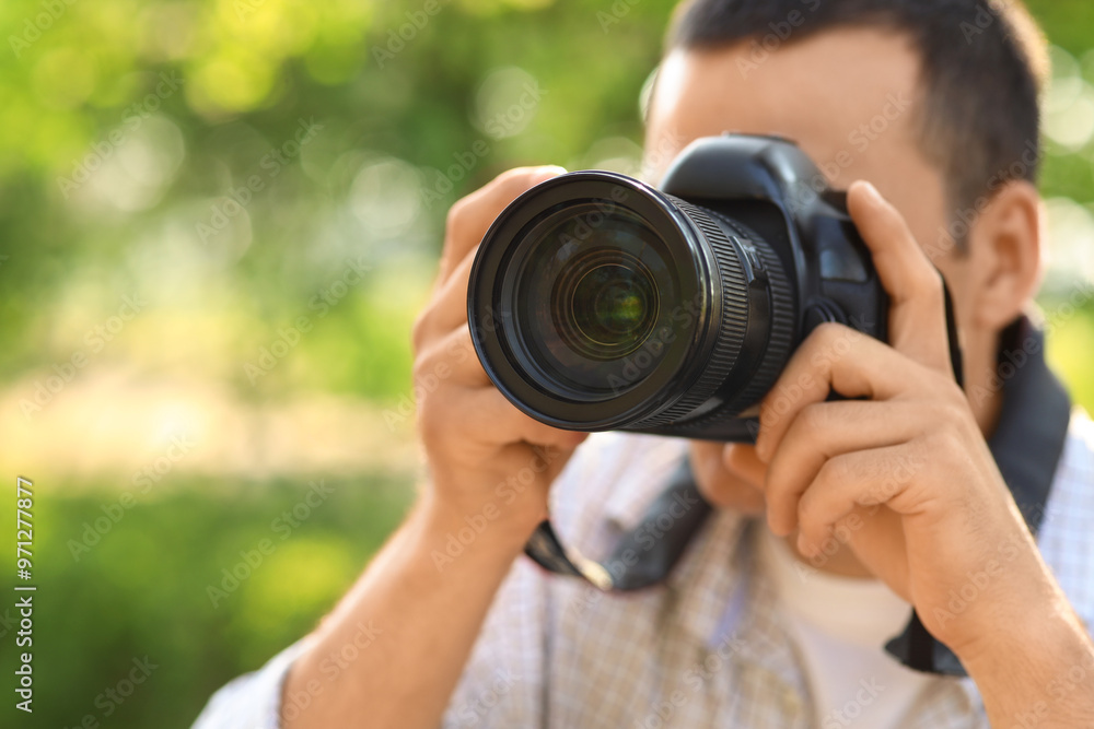 Male photographer with modern camera outdoors Male photographer with modern camera outdoors