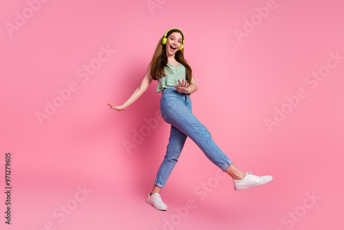 Full body portrait of pretty young girl headphones dance wear top isolated on pink color background