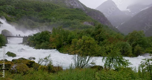 Kleivafossen waterfall and surrounding mountains in Jostedalsbreen National park, Norway photo