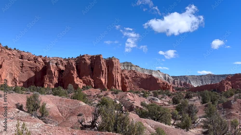 Panoramic view of the red rock formations and desert landscape of Kodachrome Basin State Park in Utah, USA. The blue sky provides a beautiful contrast to the red rocks and green vegetation. Panoramic view of the red rock formations and desert landscape of Kodachrome Basin State Park in Utah, USA. The blue sky provides a beautiful contrast to the red rocks and green vegetation.