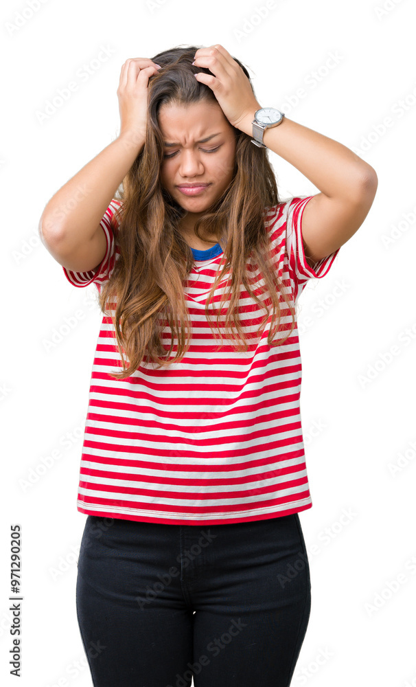 Young beautiful brunette woman wearing stripes t-shirt over isolated background suffering from headache desperate and stressed because pain and migraine. Hands on head. Young beautiful brunette woman wearing stripes t-shirt over isolated background suffering from headache desperate and stressed because pain and migraine. Hands on head.