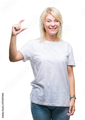 Young beautiful blonde woman wearing white t-shirt over isolated background smiling and confident gesturing with hand doing size sign with fingers while looking and the camera. Measure concept.