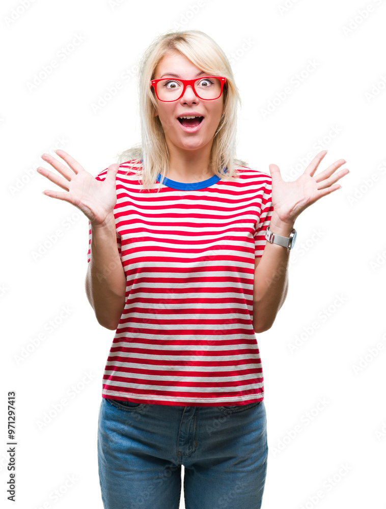 Young beautiful blonde woman wearing glasses over isolated background celebrating crazy and amazed for success with arms raised and open eyes screaming excited. Winner concept Young beautiful blonde woman wearing glasses over isolated background celebrating crazy and amazed for success with arms raised and open eyes screaming excited. Winner concept
