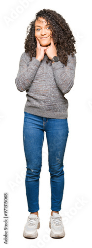 Young beautiful woman with curly hair wearing grey sweater Smiling with open mouth, fingers pointing and forcing cheerful smile