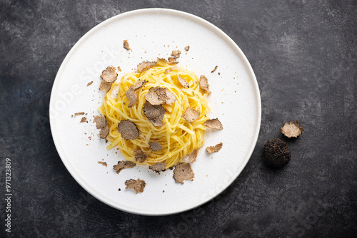 Wallpaper Mural Black truffle pasta Tajarin. Black rustic table, magical autumn light, front view. Autumn gourmet cuisine of Piedmont, Northern Italy, Spain and France Torontodigital.ca
