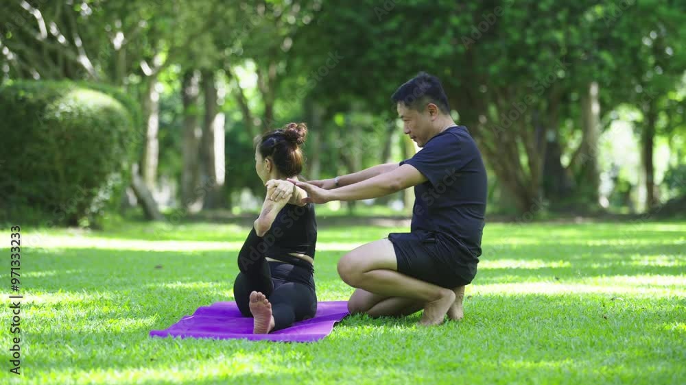 Yoga instructor helping woman stretching body Yoga instructor helping woman stretching body