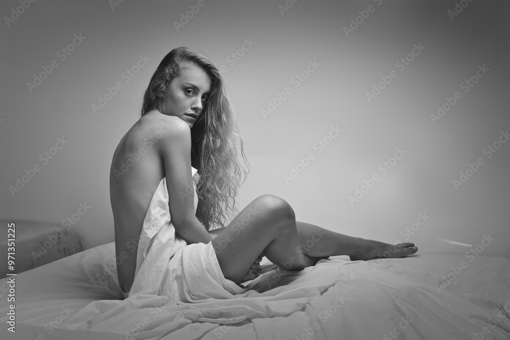 beautiful woman sitting on a bed