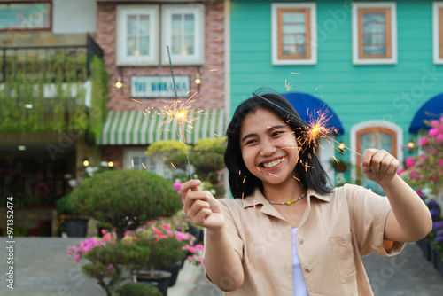 фотографія portrait of beautiful happy young asian woman holding sparklers fireworks to cel