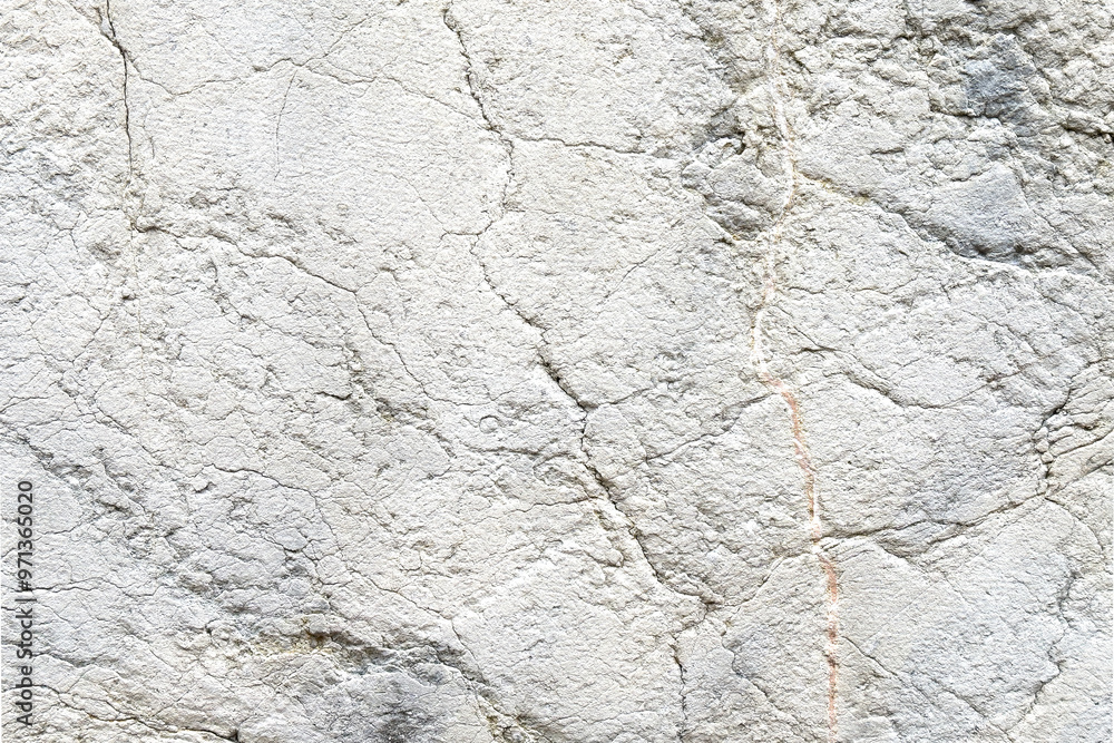 Distressed aged gray stone wall with cracks and scratches of abstract surface Distressed aged gray stone wall with cracks and scratches of abstract surface
