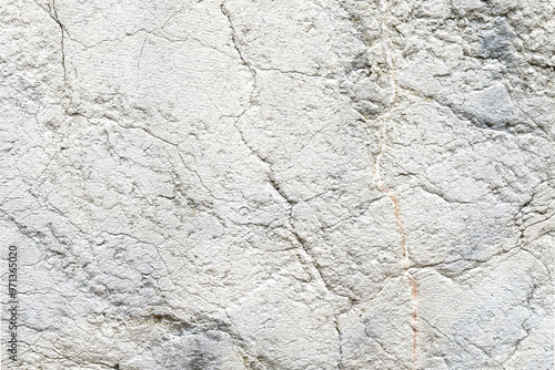 Distressed aged gray stone wall with cracks and scratches of abstract surface
