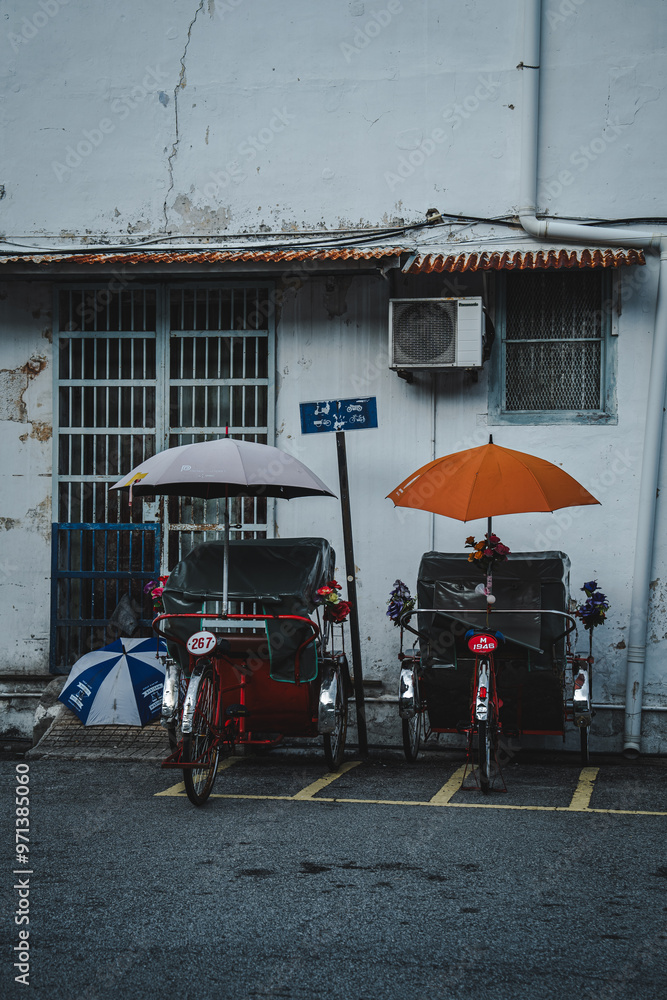 Obraz premium A Street view or street scene, road, view of cityscape in Georgetown, Penang on 3 July 2024, unesco world heritage site, travel destinations. Life at night time, love rain road, light and traffic.