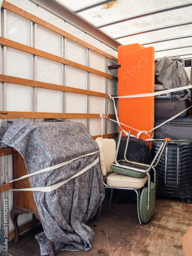 The inside of a removal van, showing fabric blankets , furniture and sofa. Concept for moving home, furniture protection, storage, packing and transportation. Copy space.