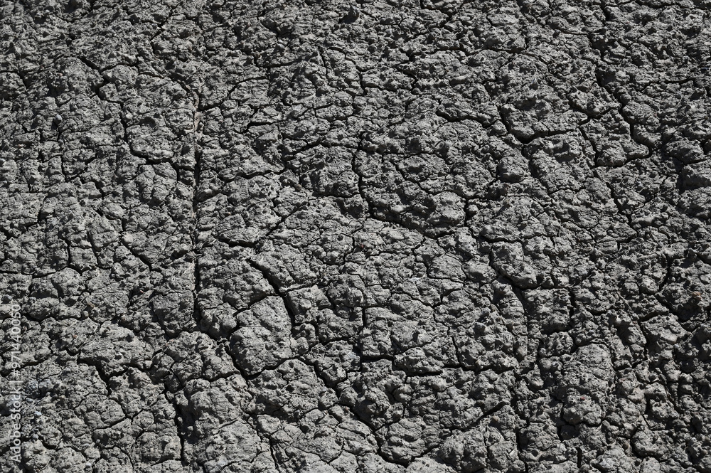 Texture of a black grey gray dry volcanic stone rock background. Texture of a black grey gray dry volcanic stone rock background.