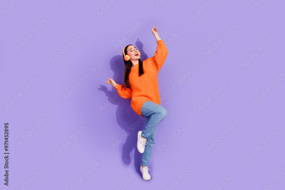 Photo of lovely cheerful girl wear trendy orange clothes listen music isolated on purple color background