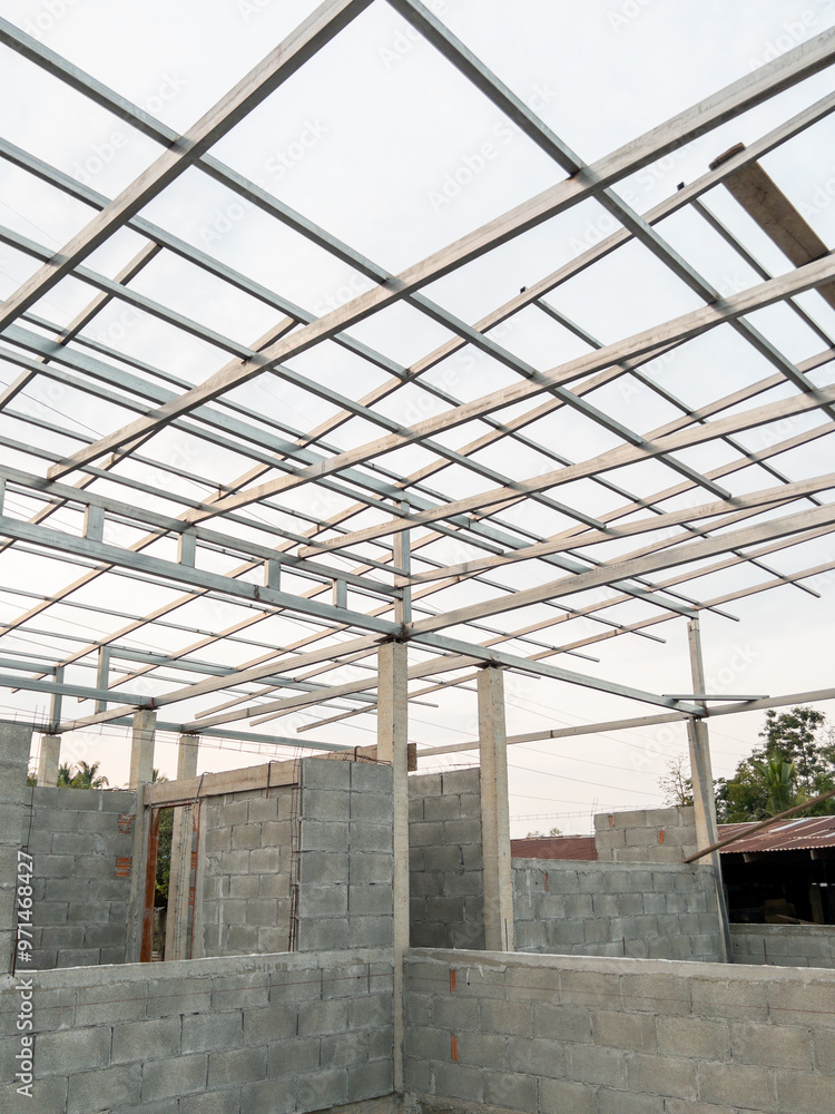 The unfinished house with the metal frame for the roof. The unfinished house with the metal frame for the roof.