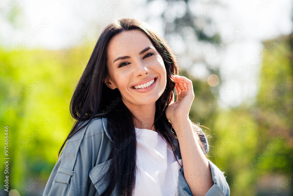Portrait photo of beautiful young smiling latin attractive lady wearing gray coat relaxed in nature enjoying sunny weather Portrait photo of beautiful young smiling latin attractive lady wearing gray coat relaxed in nature enjoying sunny weather
