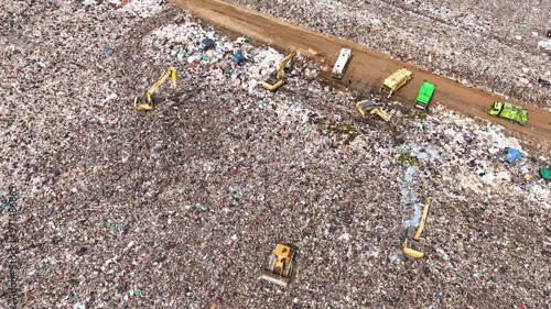 Wallpaper Mural Time-lapse aerial view of large garbage, waste, landfill, workers sorting garbage in a landfill, garbage trucks dumping garbage that causes global warming pollution. Torontodigital.ca