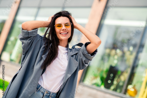 Photo of good mood positive woman wear grey trench dark glasses smiling enjoying walk outdoors urban city street