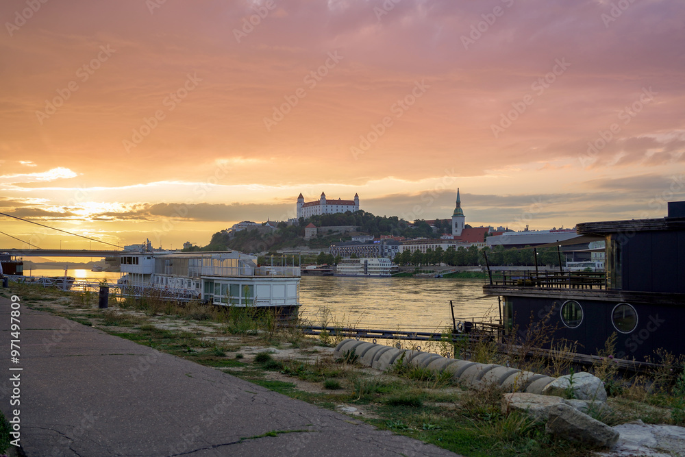 bright sunset over Bratislava castle and Danube riverbanks bright sunset over Bratislava castle and Danube riverbanks