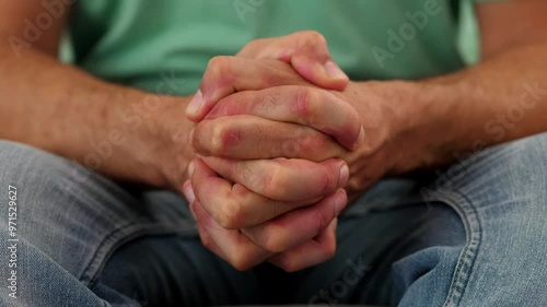 Close-up of hands clenching tightly in anger. The clip focuses on the intense gesture of frustration and anger through the hand movement. photo