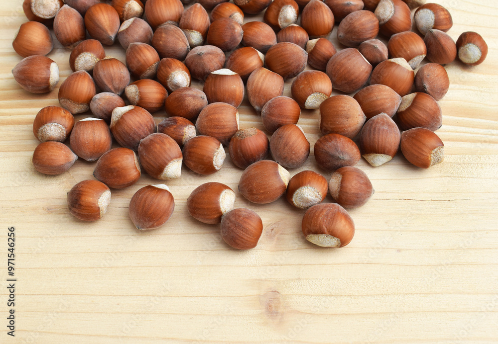 Hazelnuts in shell on a wooden background