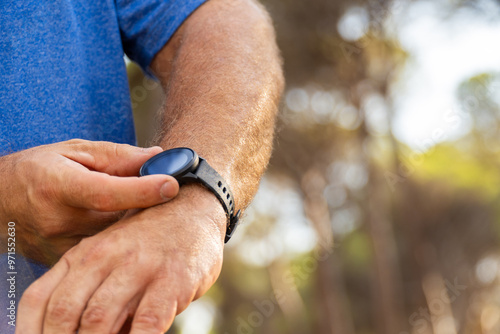 Closeup, person using the smartwatch, outdoors. photo