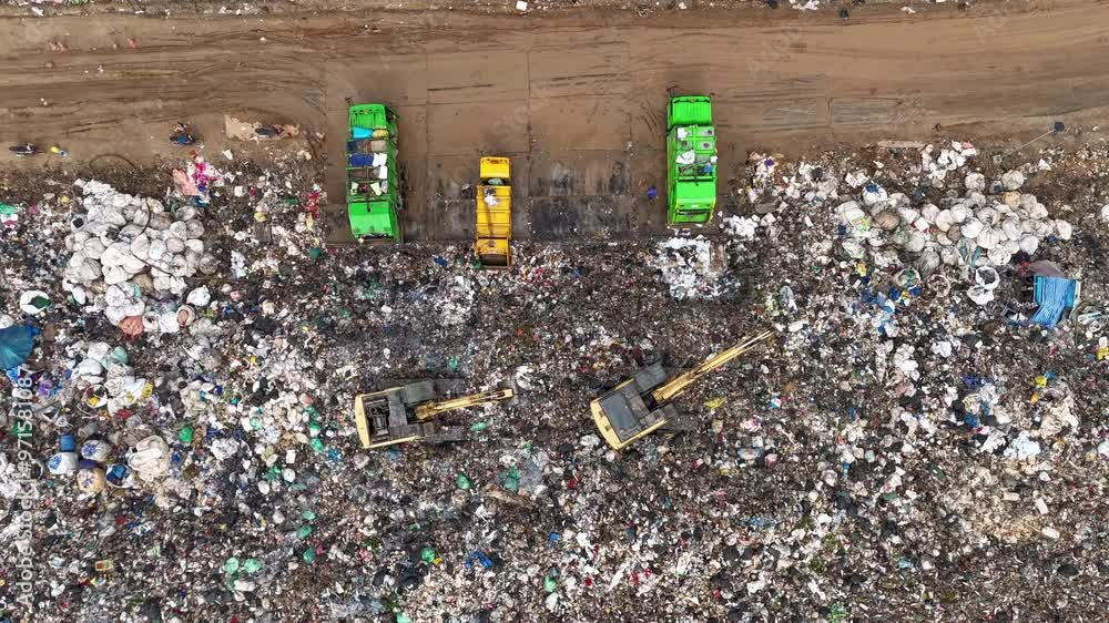 Time-lapse aerial view of large garbage, waste, landfill, workers ...