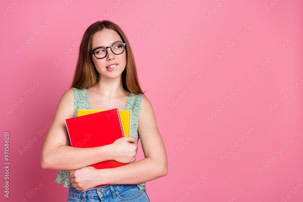 Portrait of pretty young girl look empty space wear top isolated on pink color background Portrait of pretty young girl look empty space wear top isolated on pink color background