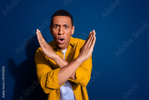Картината върху платно Portrait of nice young man crossed arms wear yellow shirt isolated on dark blue