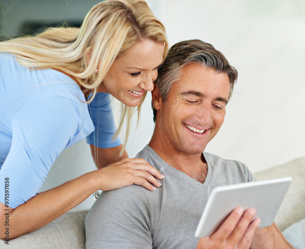 Lounge, relax and couple with tablet, watch and browsing of movie, showing and subscription for entertainment. House, man and woman with app, streaming and happy in living room, scroll and bonding Lounge, relax and couple with tablet, watch and browsing of movie, showing and subscription for entertainment. House, man and woman with app, streaming and happy in living room, scroll and bonding