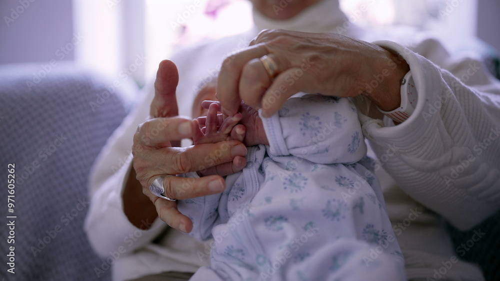 Close-up of an elderly woman gently holding a newborn baby's tiny hand, emphasizing the tender connection and delicate bond between generations in a peaceful and intimate moment Close-up of an elderly woman gently holding a newborn baby's tiny hand, emphasizing the tender connection and delicate bond between generations in a peaceful and intimate moment