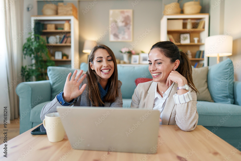 Cheerful Female Friends Enjoying Laptop Video Call at Home Cheerful Female Friends Enjoying Laptop Video Call at Home