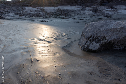 Sun bounces off of clay sand in glacial pond photo