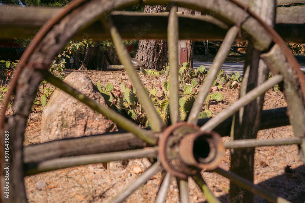 A wooden wheel from a cart. Western style wagon wheel. A wooden wheel from a cart. Western style wagon wheel.