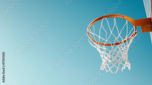 Perfect shot, basketball scoring against a clear sky.