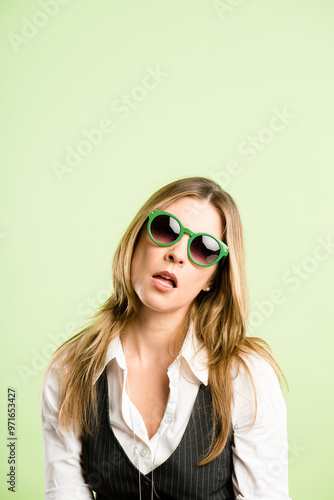 Fashion, sunglasses and face of woman on green background with cool, trendy style and accessories. Attitude, mockup and portrait of person with eyewear for aesthetic, pride and confident in studio